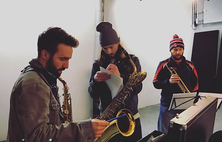 Jeff with his tenor saxophone at a studio session, working through a chart with a baritone saxophonist and a trumpet player